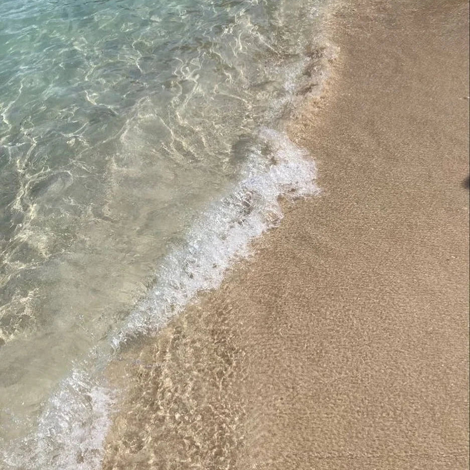 Close-up of waves crashing onto a sandy beach