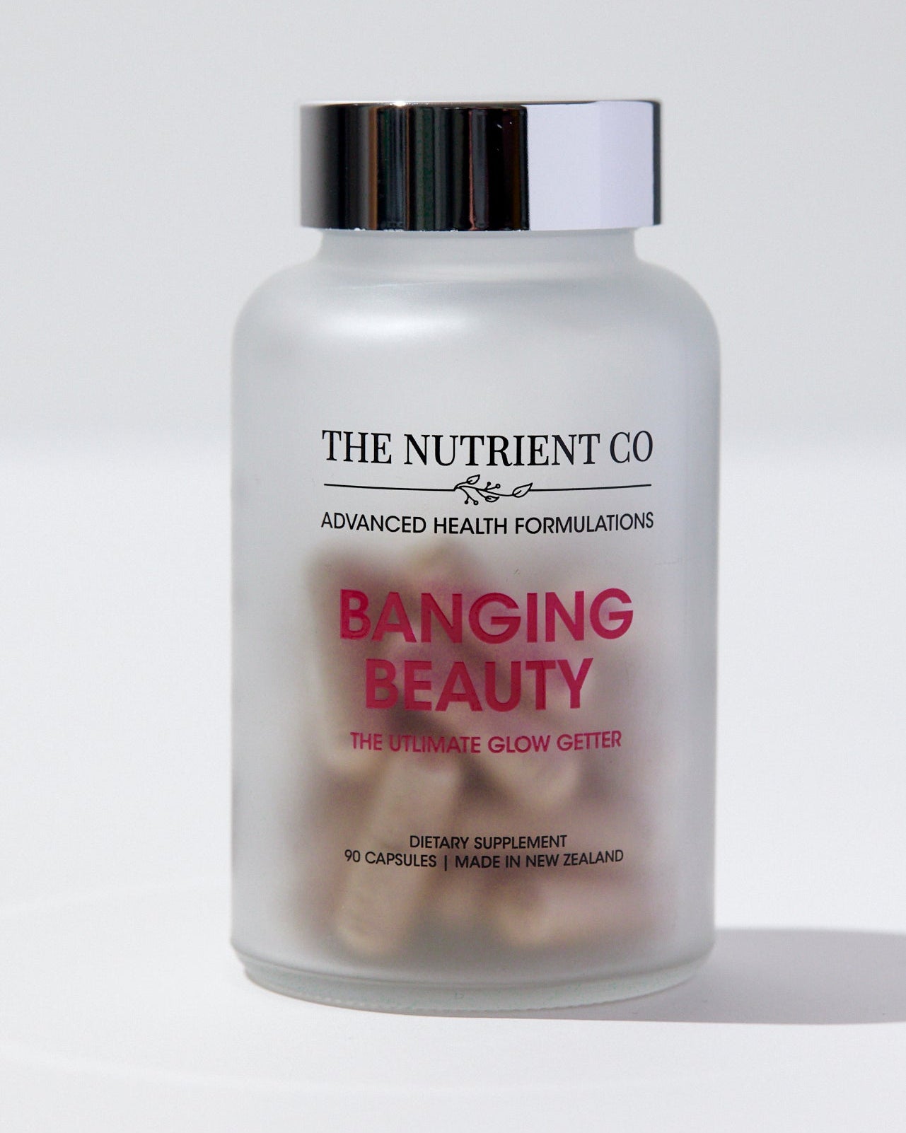 Supplement bottle labeled 'The Nutrient Co Banging Beauty' on a white background
